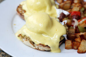 Eggs Benedict and Diced fried potato. Breakfast or Brunch