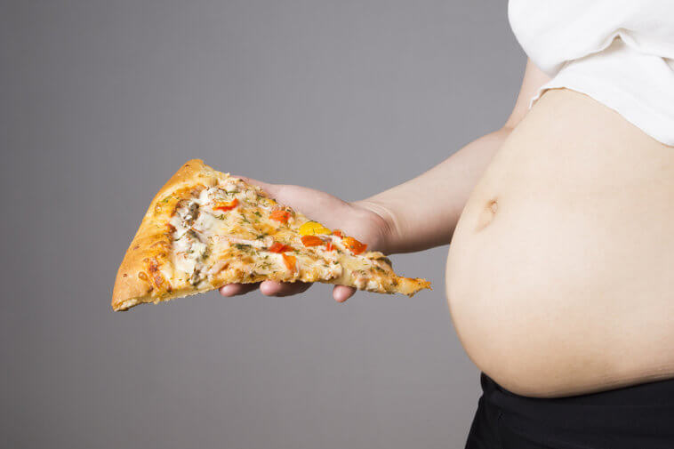 Close-Up-Of-A-Pregnant-Belly-With-Pizza